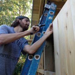 Andrew Ranville buttoning up the new Sauna cabin